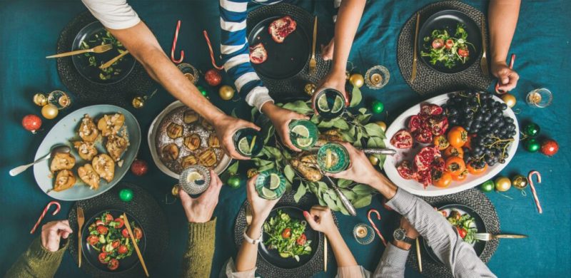 Company of friends or family gathering for Christmas dinner